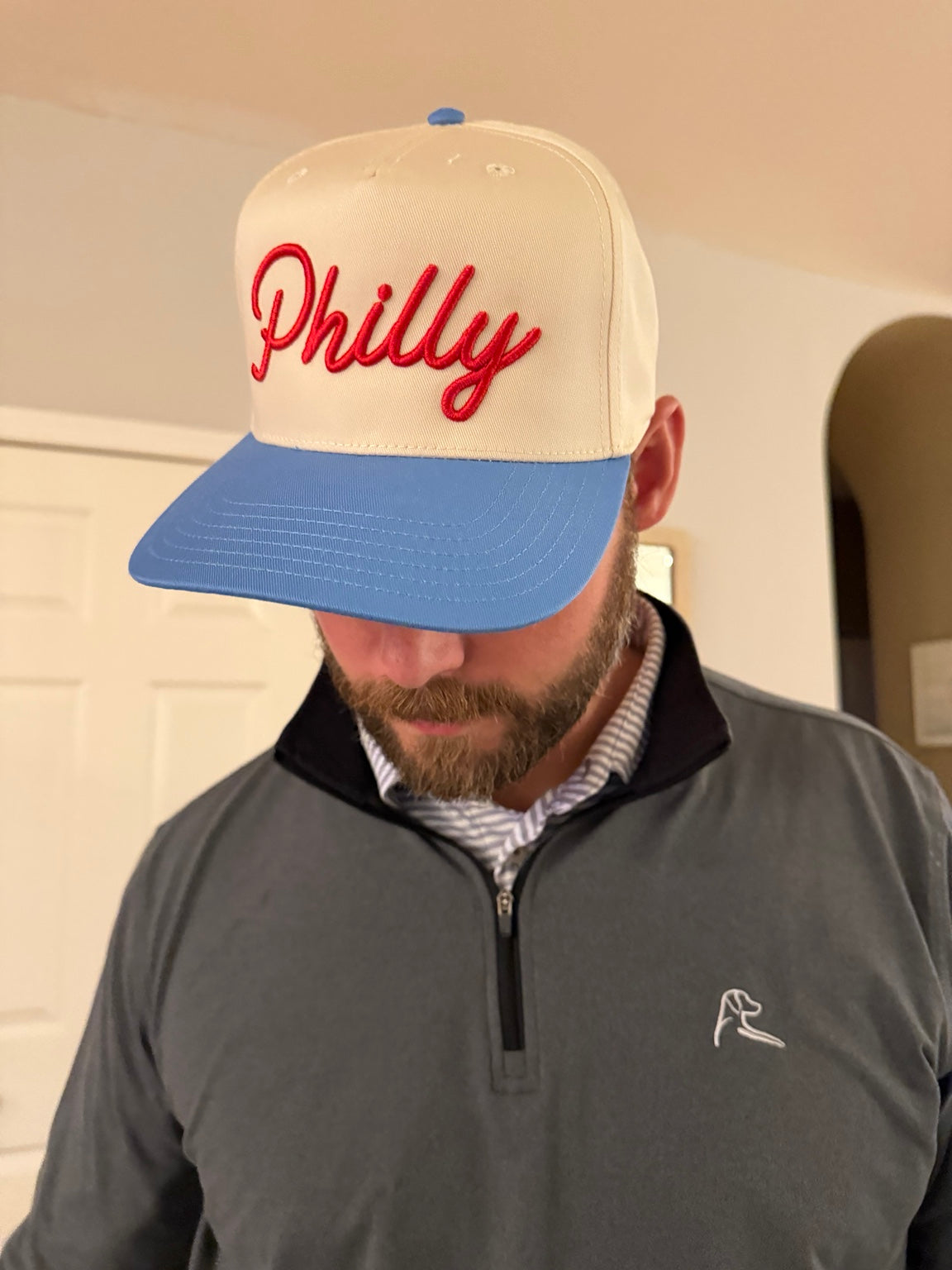 Adult wearing cream and Carolina blue Philly hat with red 3D puff script embroidery