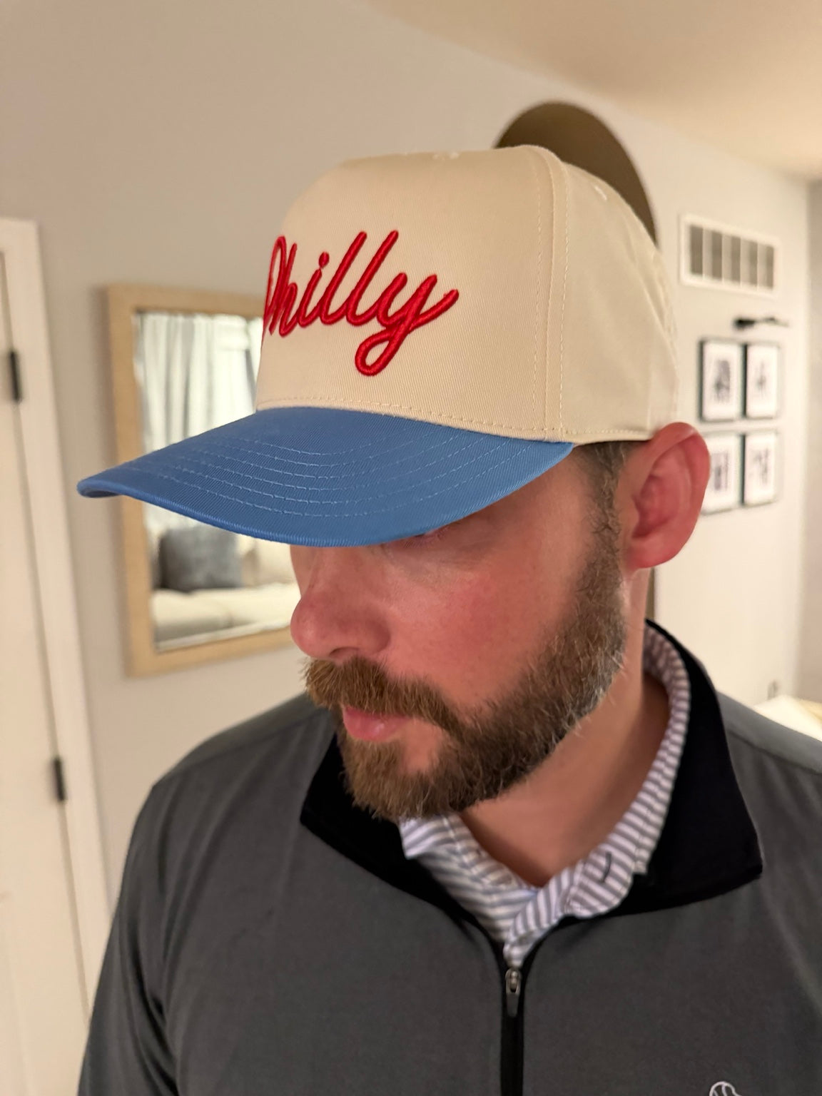 Adult wearing cream and Carolina blue Philly hat with red 3D puff script embroidery