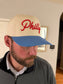 Adult wearing cream and Carolina blue Philly hat with red 3D puff script embroidery